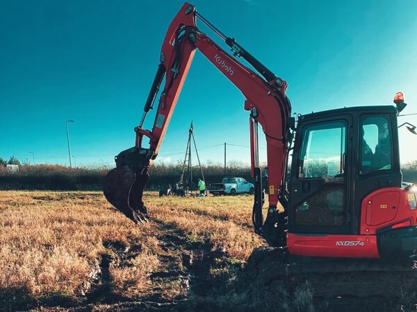 A digger in a field about to break into the soil